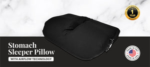 Photo of stomach sleeper pillow in black pillow case with face cradle cut out and fan for airflow through the pillow and Made in the USA stamp. 
